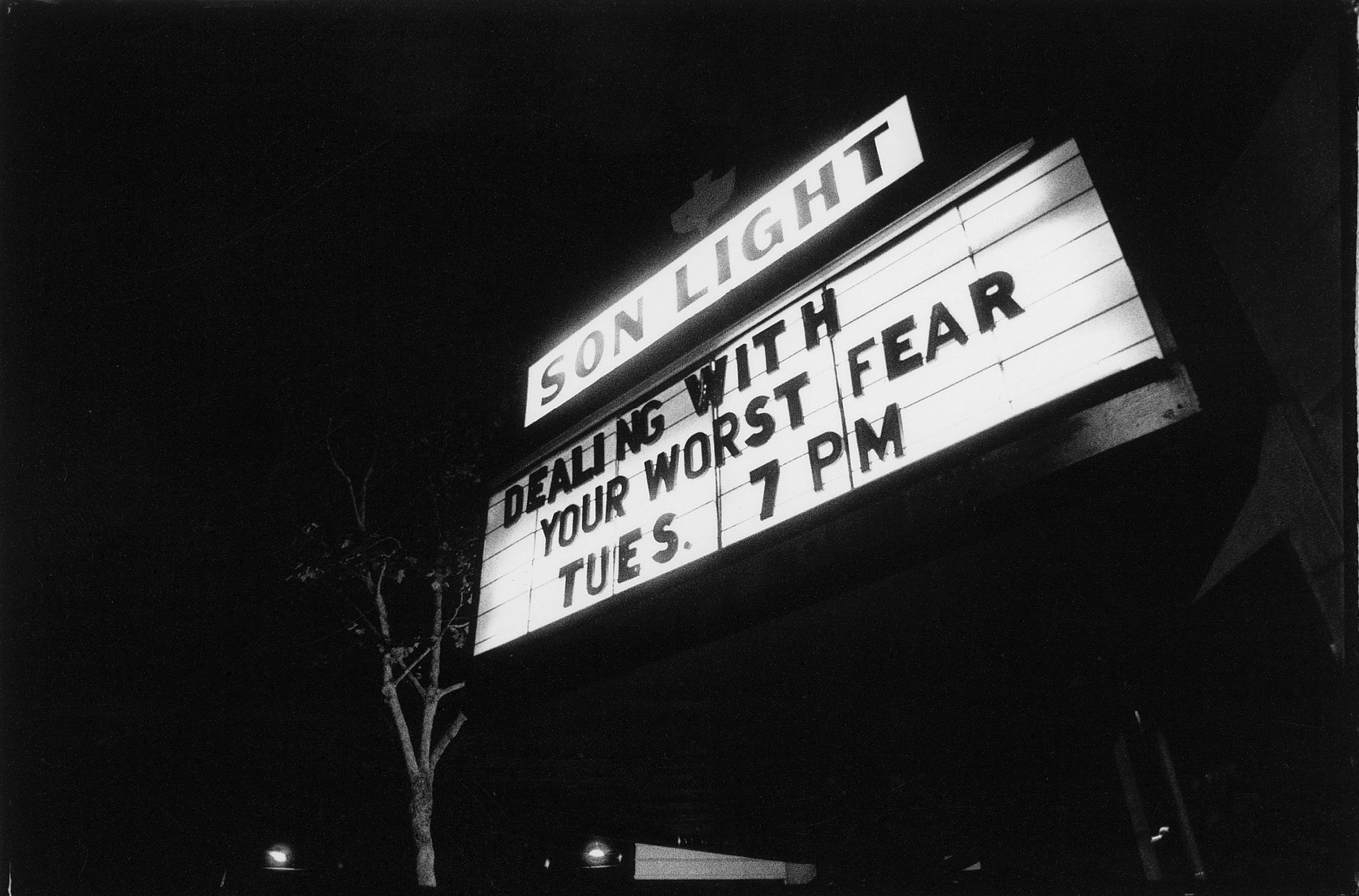 A marquee that reads “DEALING WITH YOUR WORST FEAR, TUES 7 PM.”