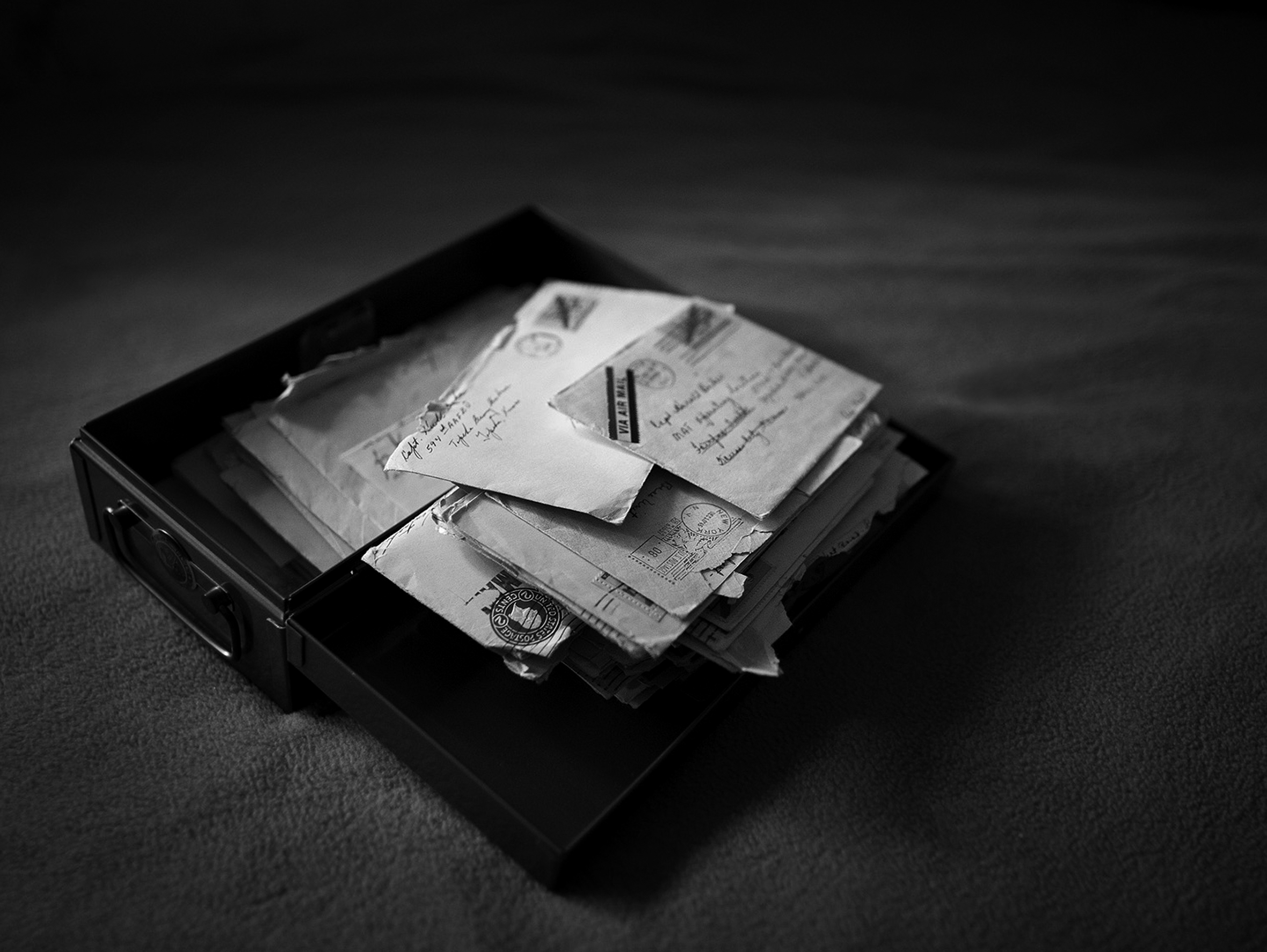 A stack of of handwritten letters in an open box
