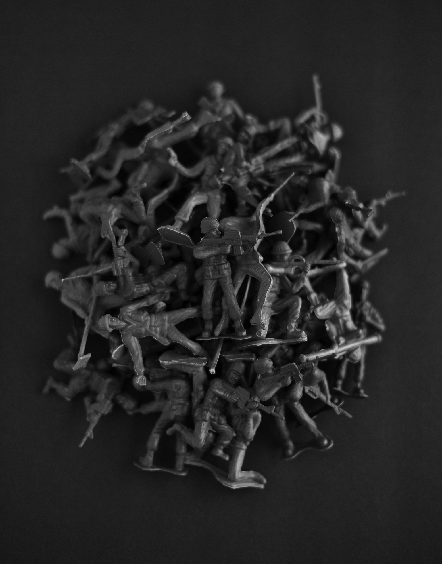 A close-up of a pile of tiny Army toy soldiers.