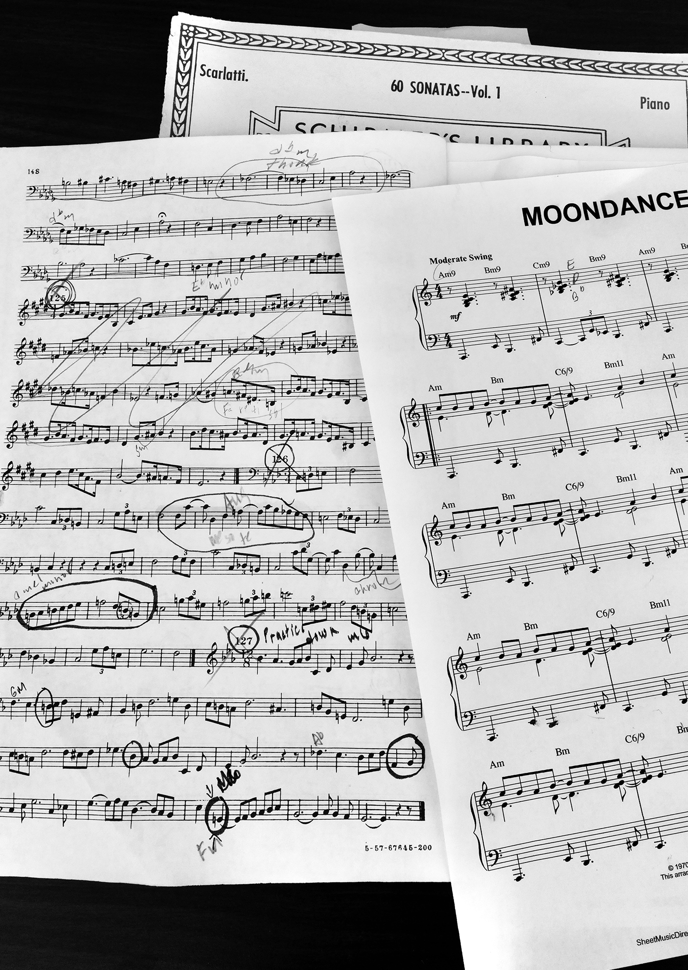 Pages of sheet music with handwritten notations. The top page says “Moondance” and the bottom page says “Scarlatti. 60 Sonatas—Vol. 1. Piano.”