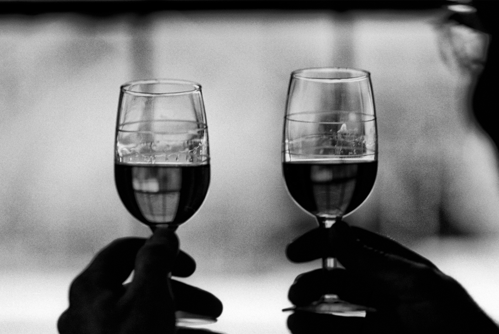 Two wine glasses held up in a toast.