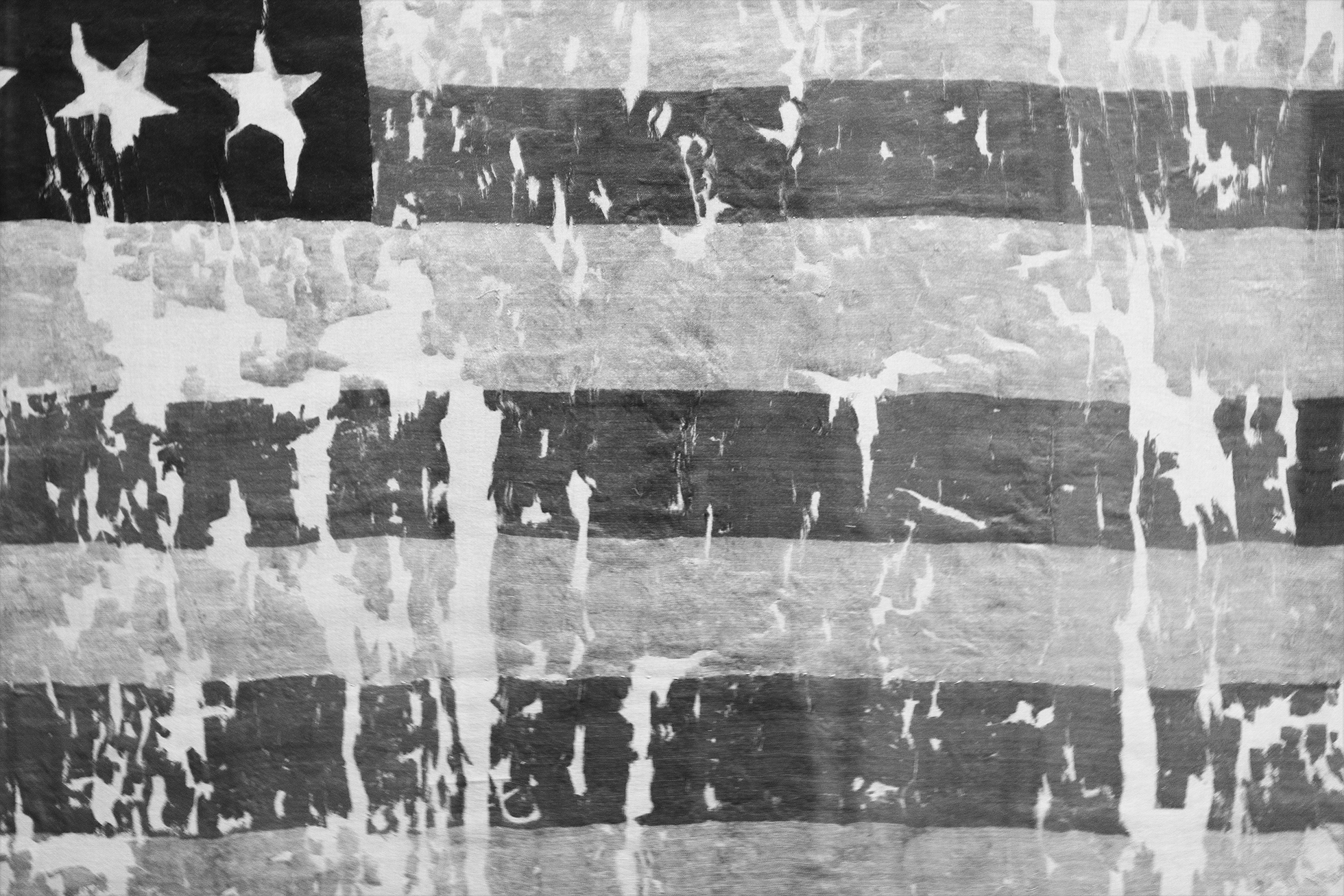 A close-up of a battered and torn American flag from the 1800s.