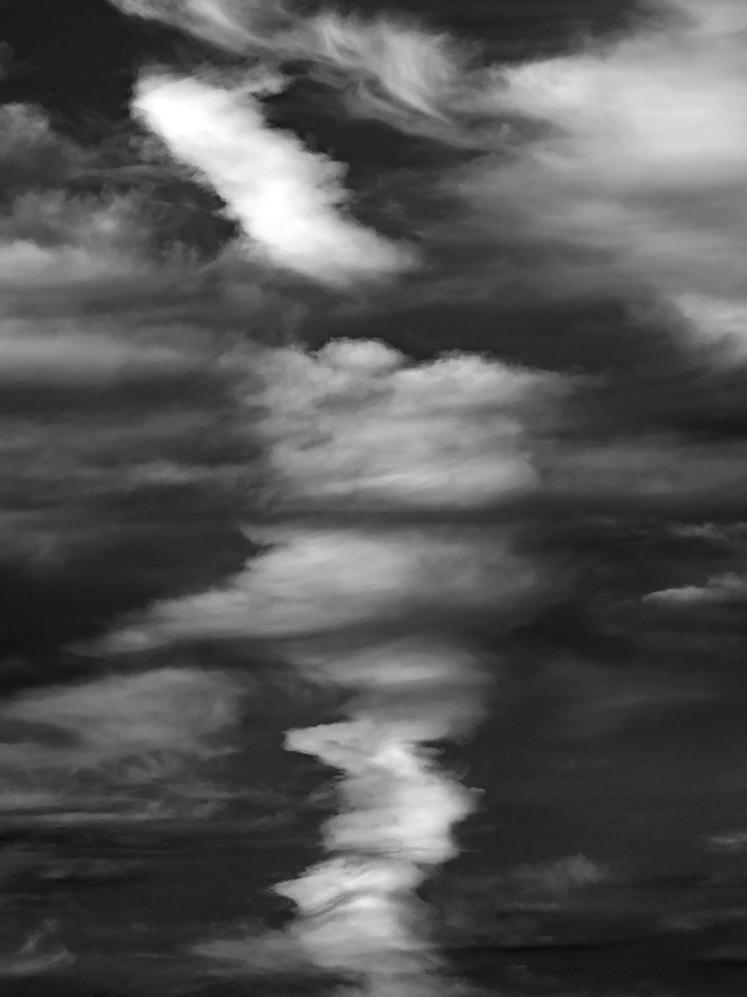 Tall photo of very dark clouds with a center vertical segment of white clouds. The photo was taken on Oregon’s Sauvie Island in 2021. Sauvie Island is a 24,000-acre island along the Columbia River.